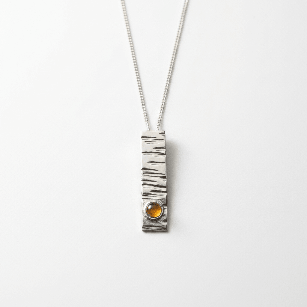 Sterling Silver hammered pendant set with an amber stone - Stellify Jewellery